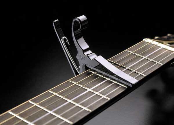 Guitar capo on strings